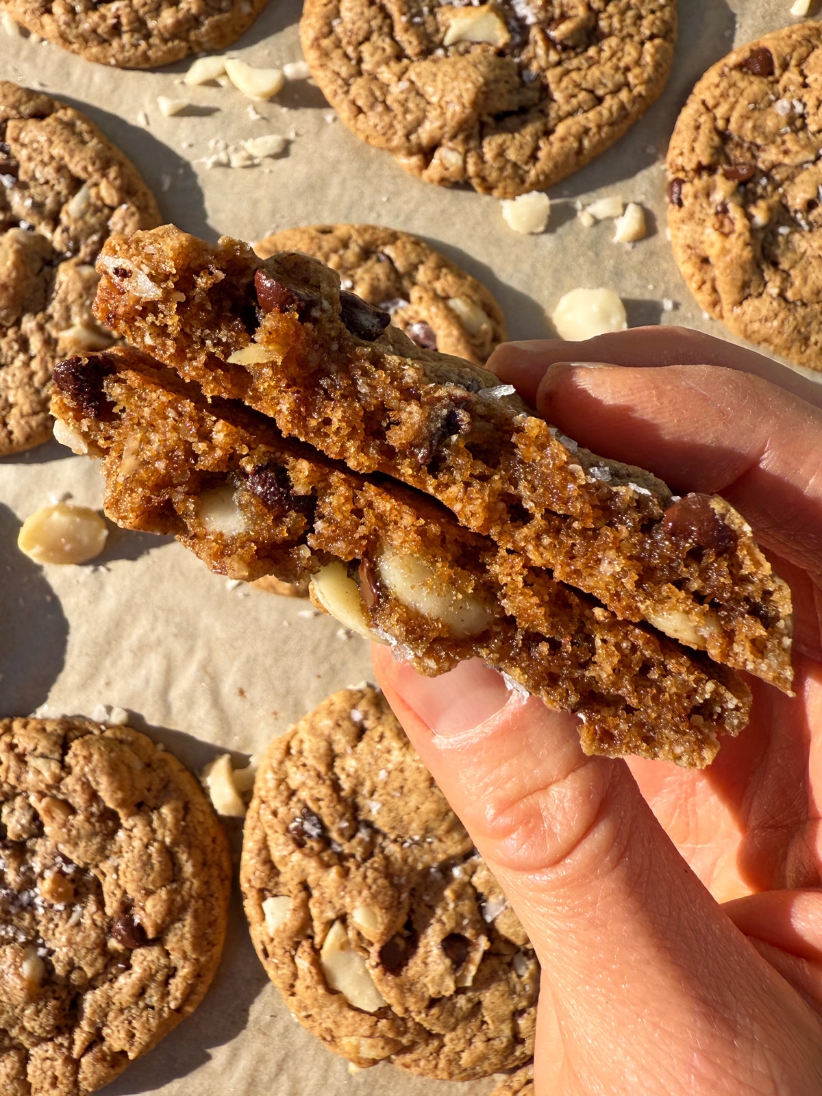Holding a cookie that's been broken in half to show the inside texture.
