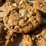 Paleo macadamia nut cookies topped with flaked salt.