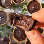 Holding an almond butter cup.