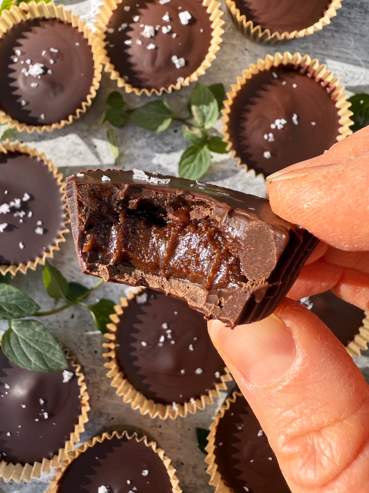 Holding an almond butter cup.