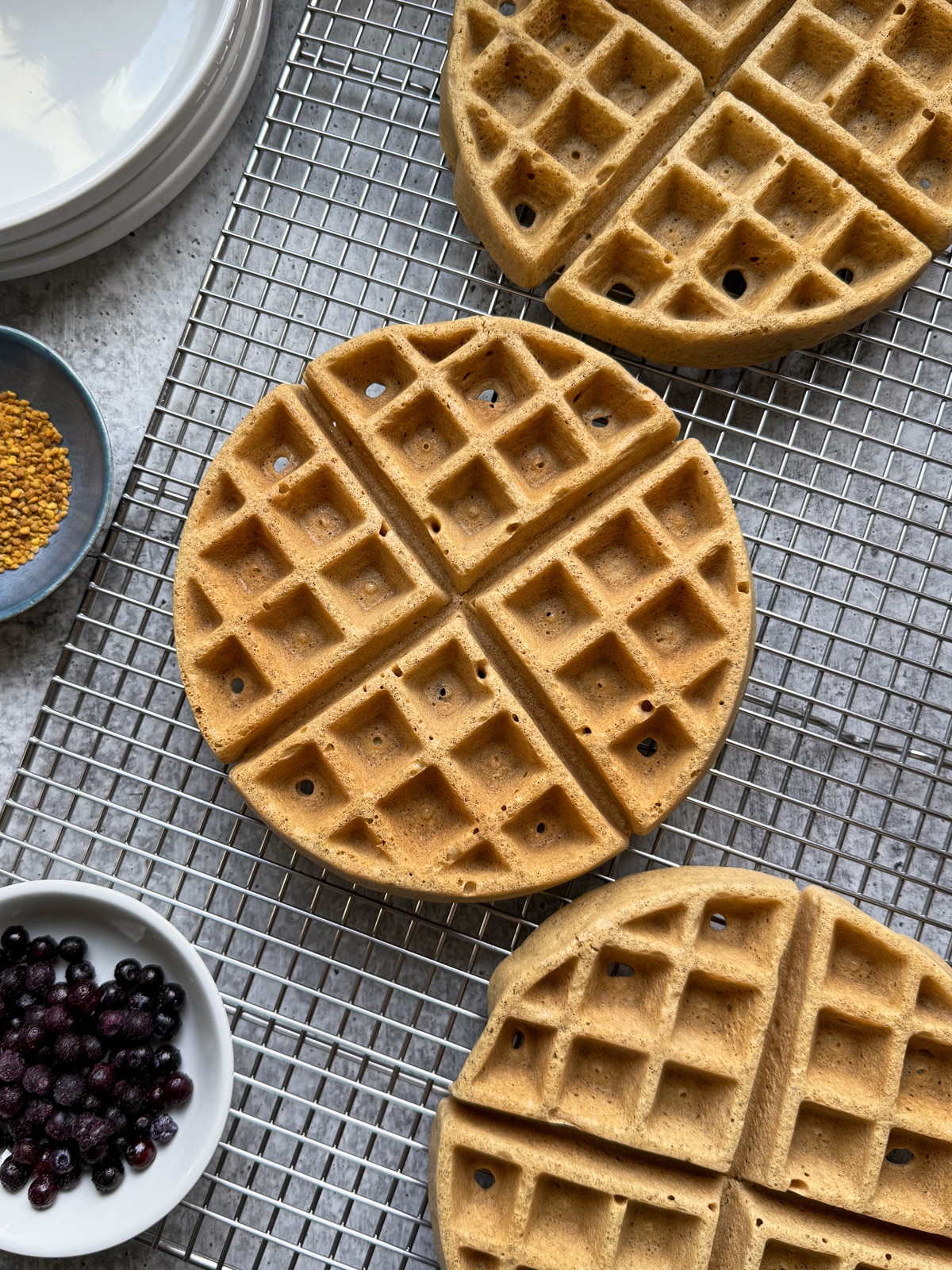 Cooked waffles on wire cooling rack.