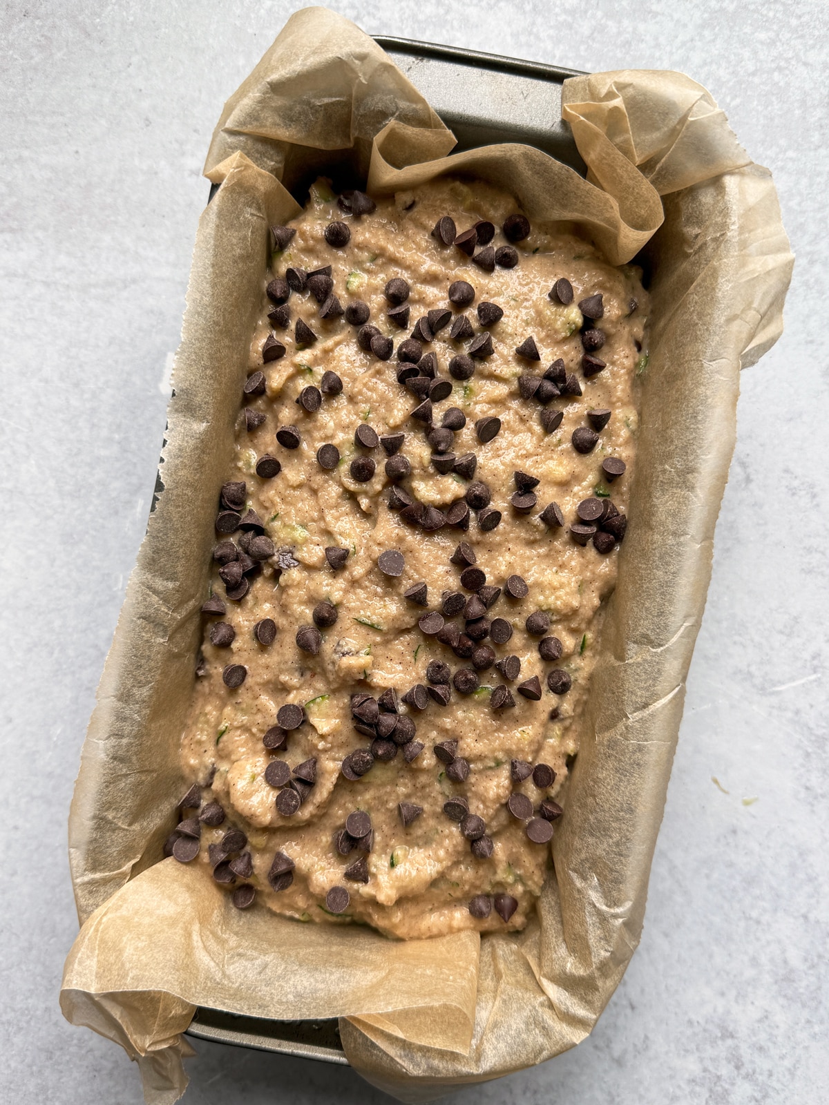 Batter in lined loaf pan, ready to bake.