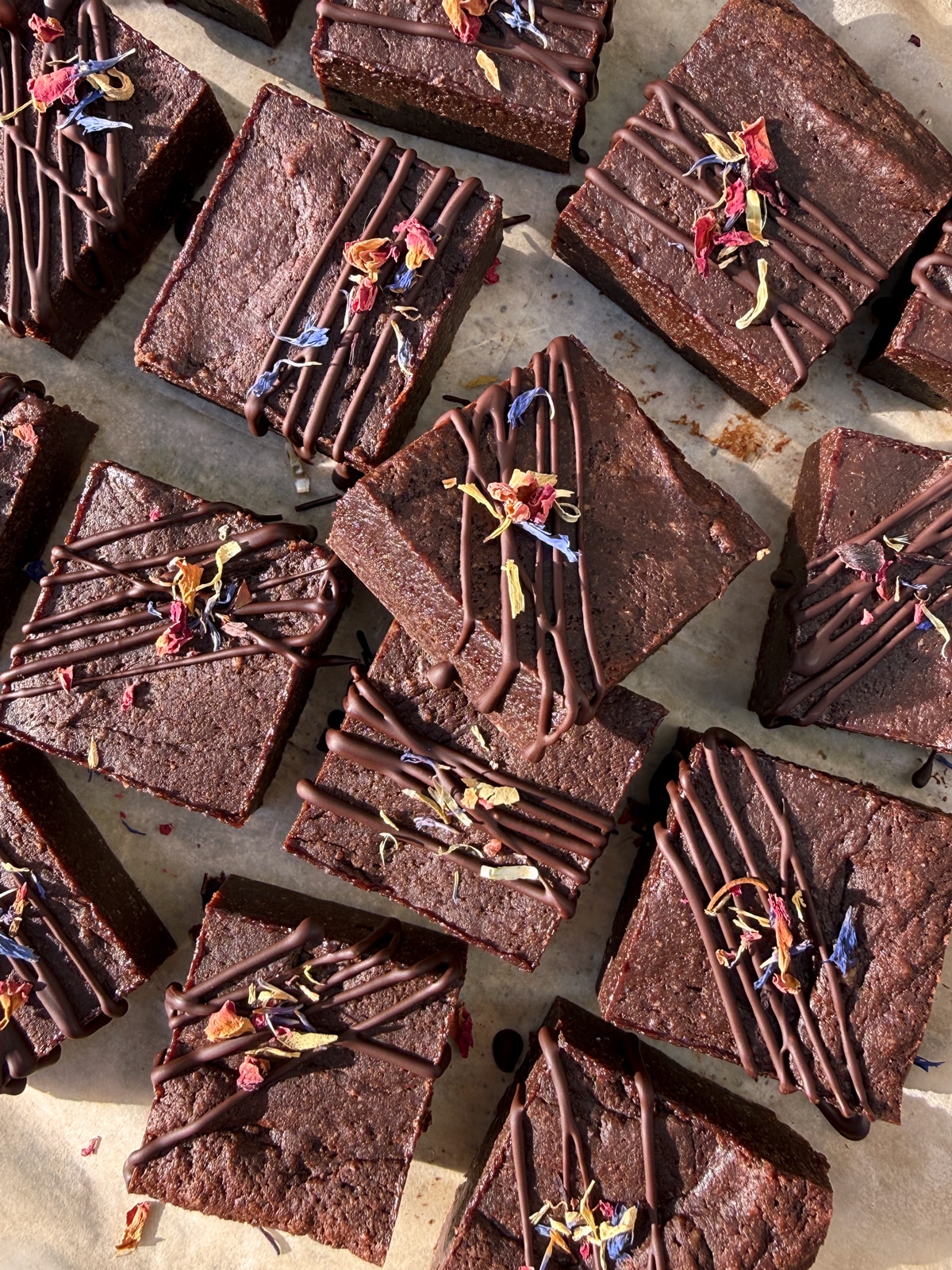 Decorated brownies on parchment paper.