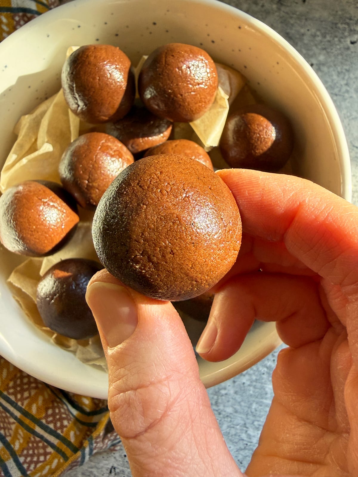 Holding a protein ball to show the size.