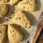 Paleo chocolate chip scones on lined baking sheet.