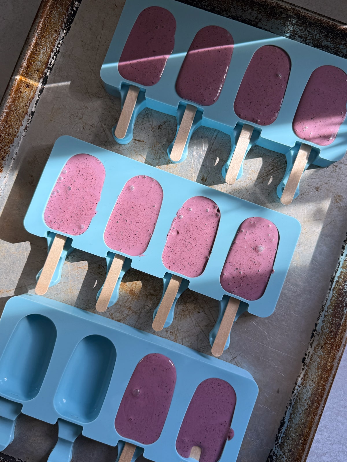 Blueberry filling in popsicle mold, ready to freeze.