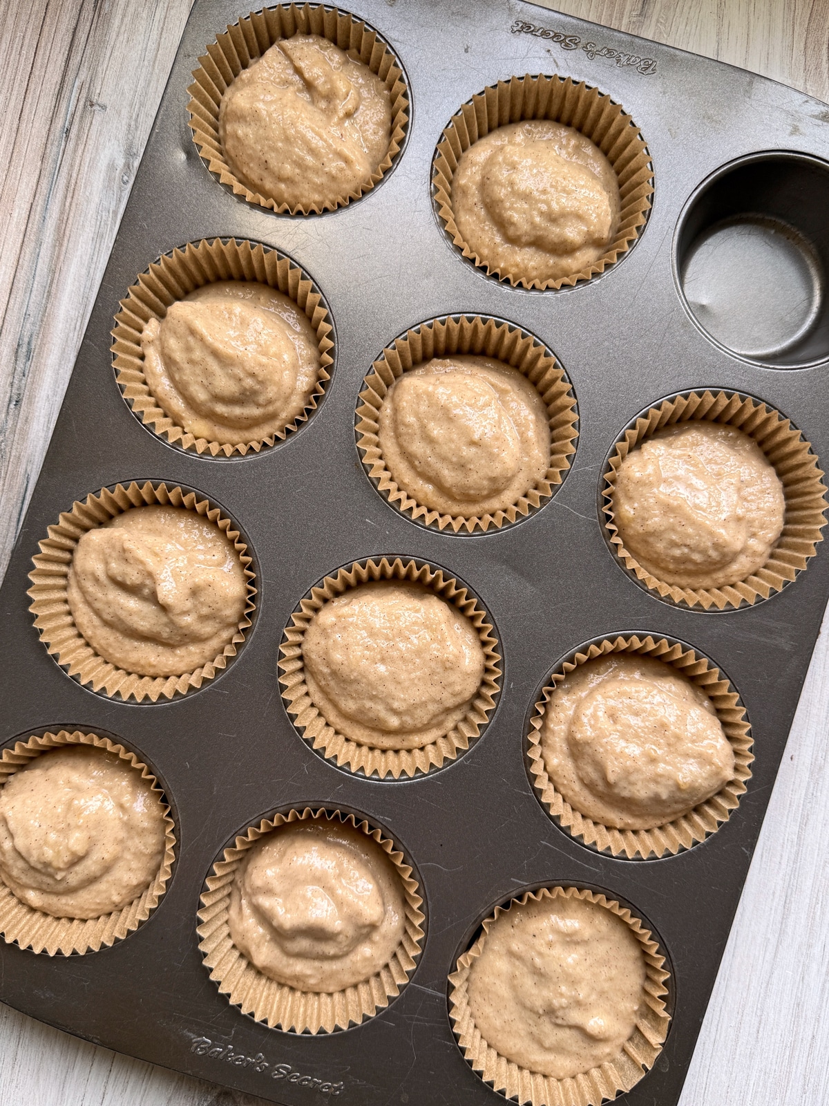 Muffin batter in muffin tin.