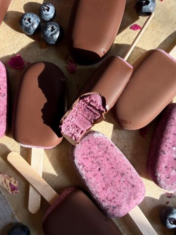 Blueberry yogurt bars on lined baking sheet.