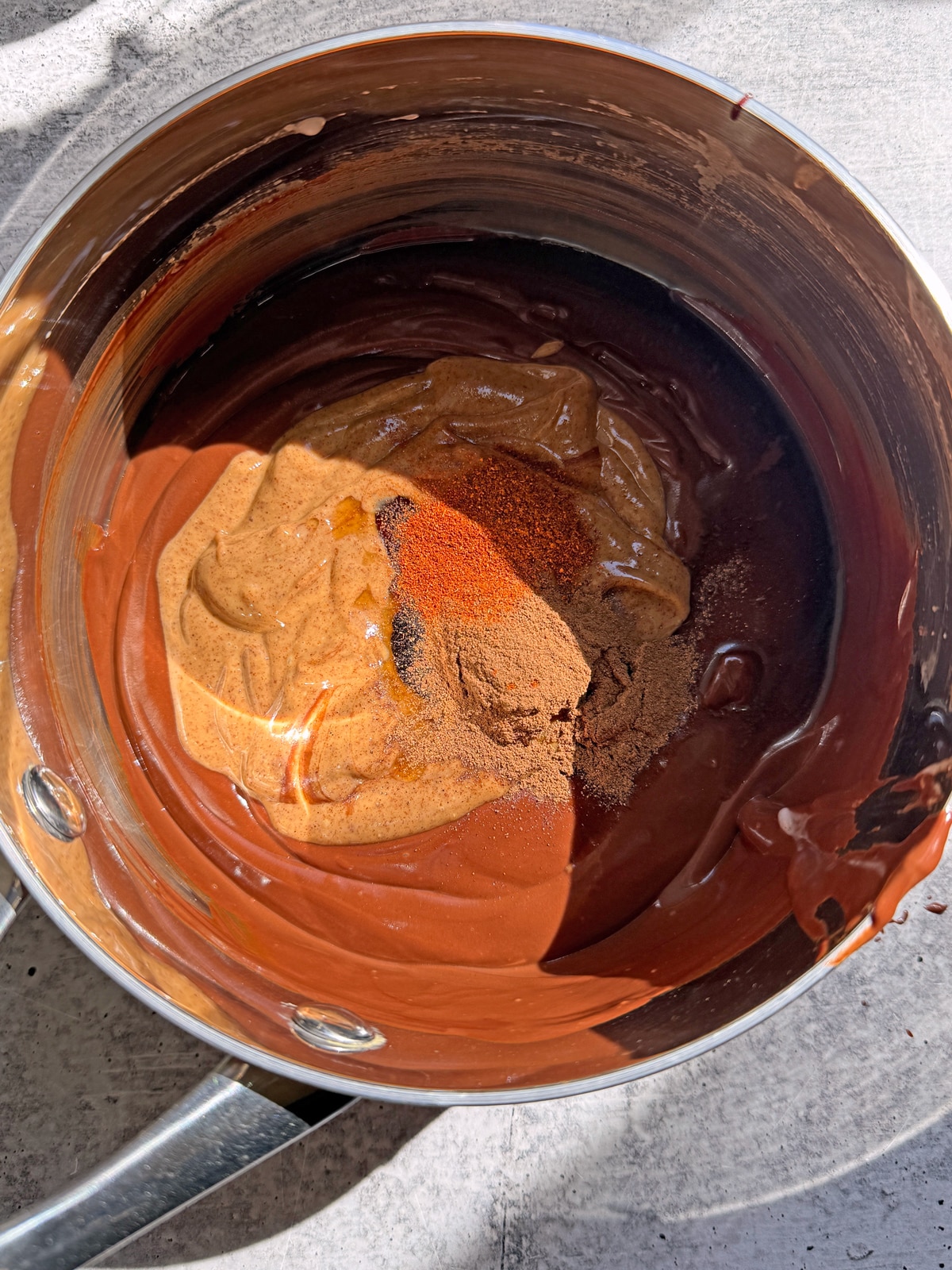 Adding in the almond butter, maple syrup and spices.