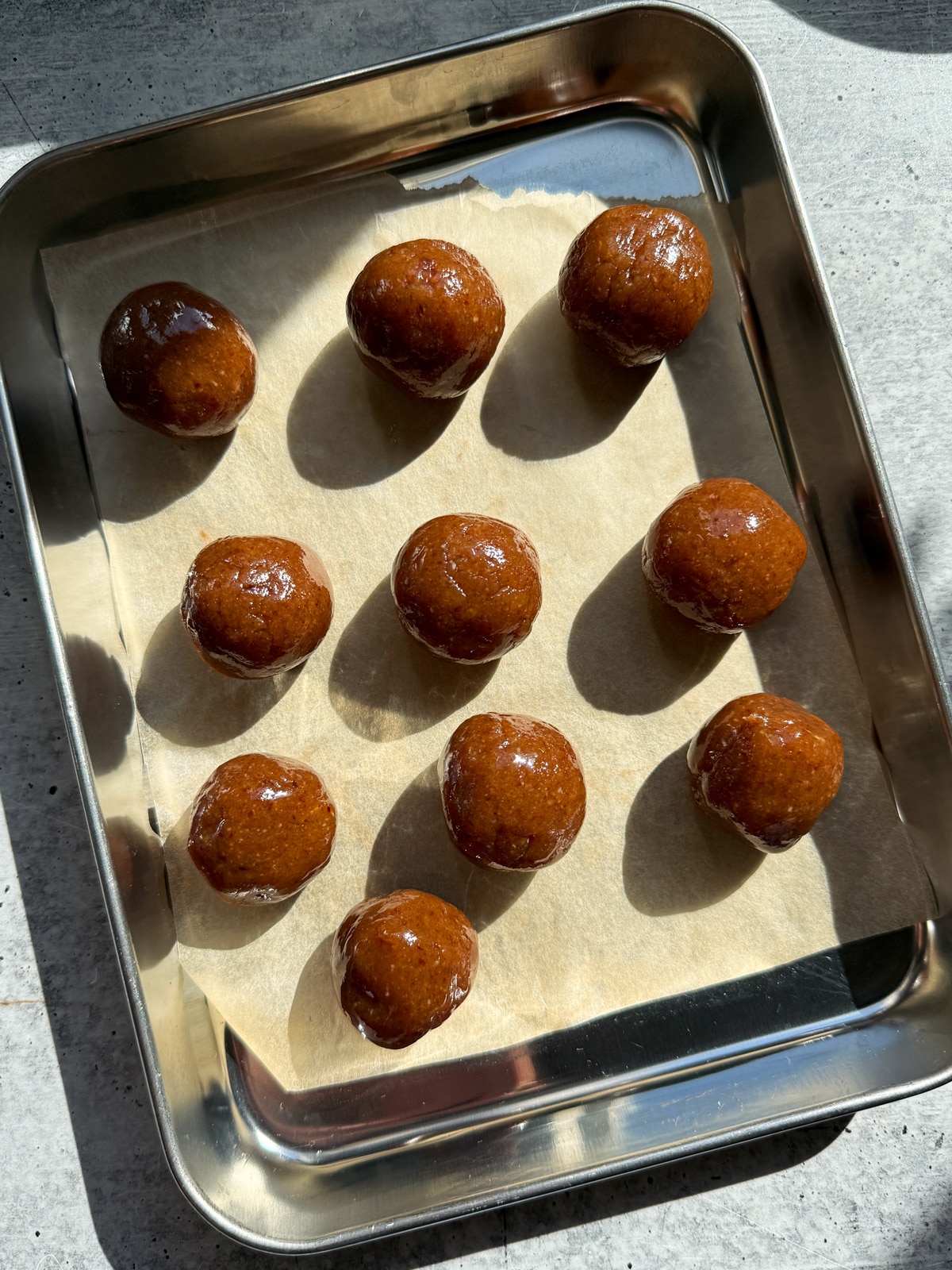 Rolled filling on lined baking sheet.