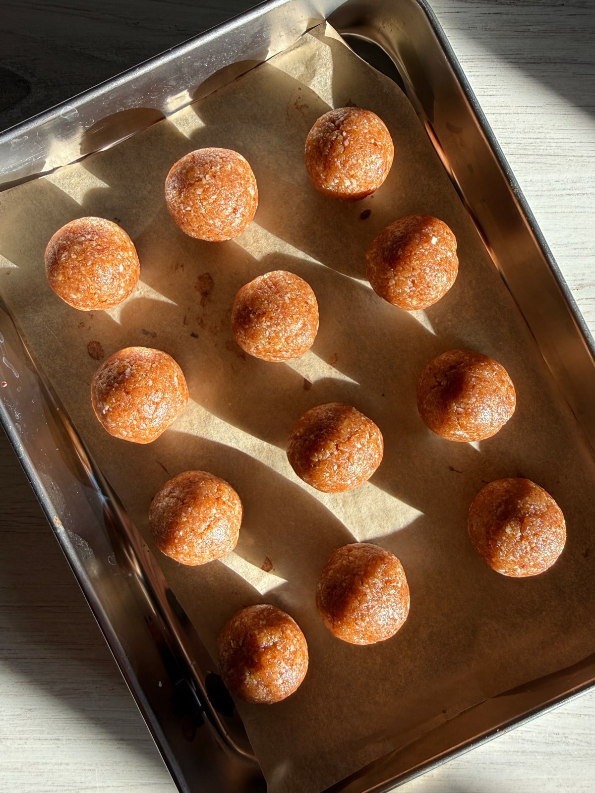 Filling rolled in to balls and set on a lined baking sheet.