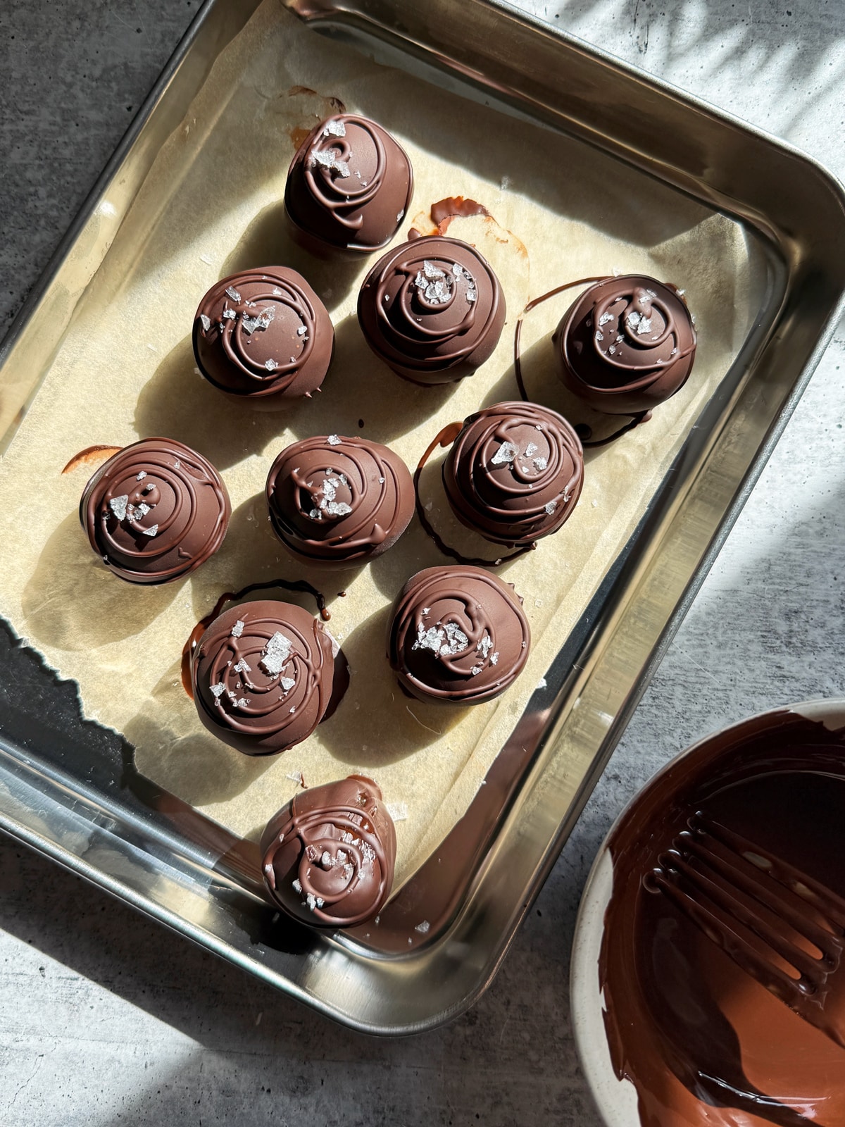 Dipping the balls in chocolate.