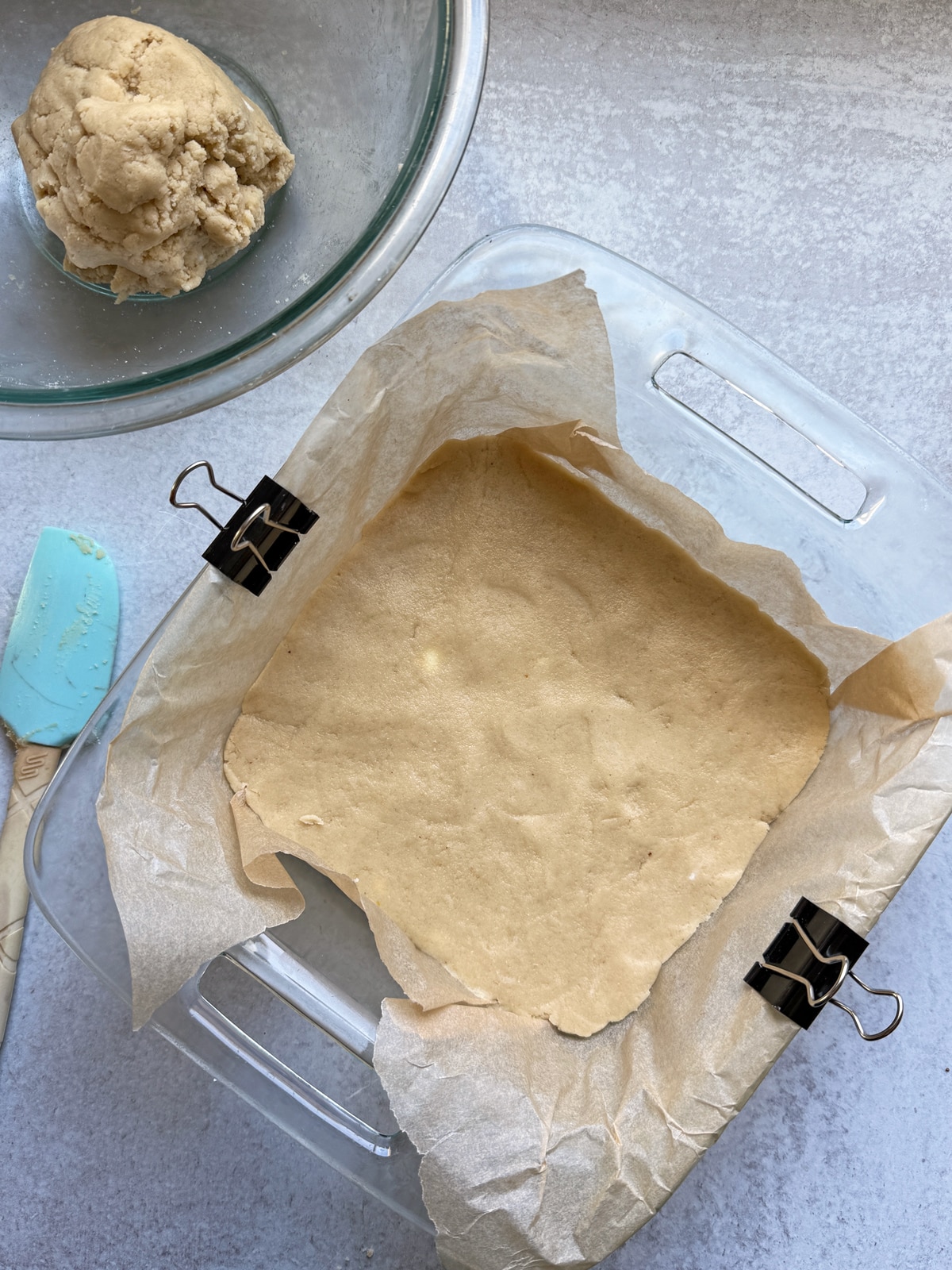 Crust pressed into a lined 8x8 inch pan.