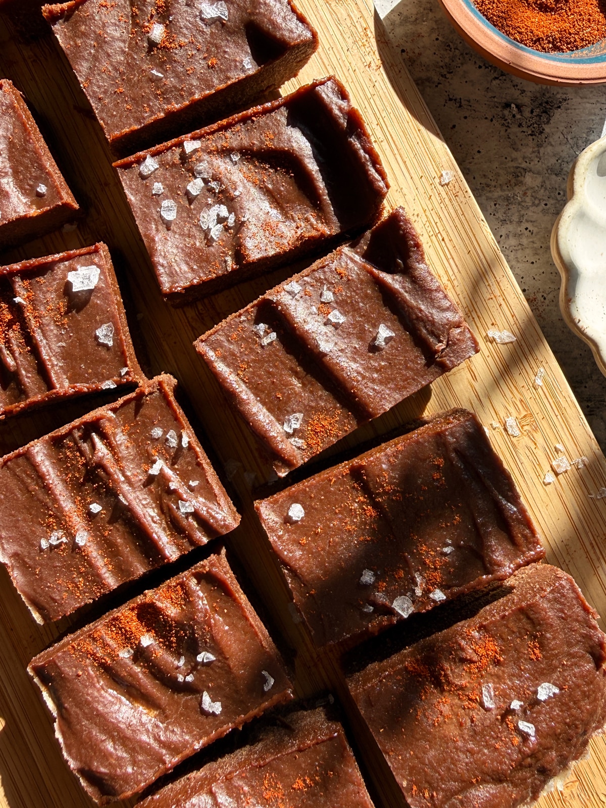 Top down view of fudge that has been cut and sprinkled with flaked salt and chili powder.