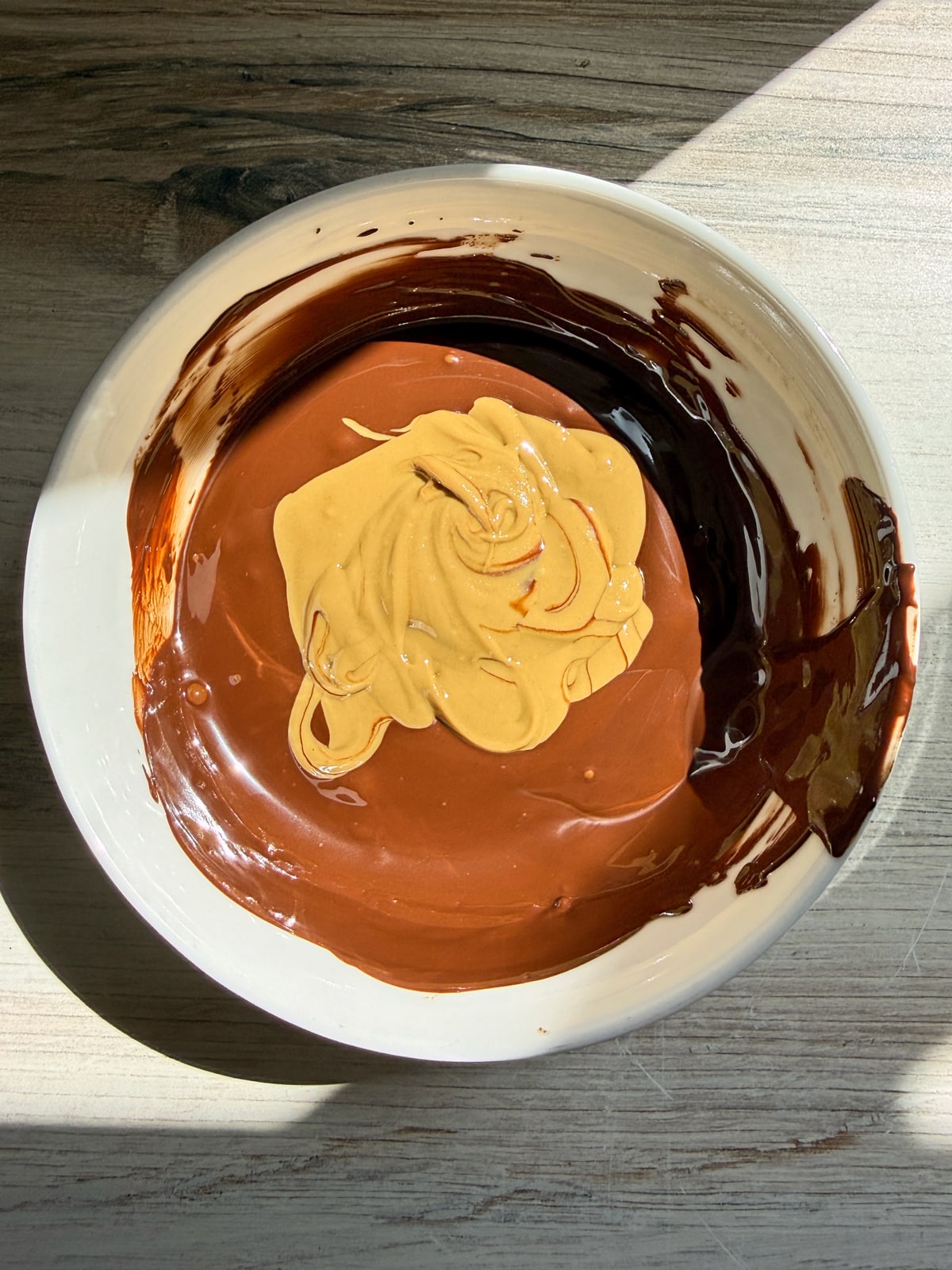 Melted chocolate in a bowl with sunbutter.