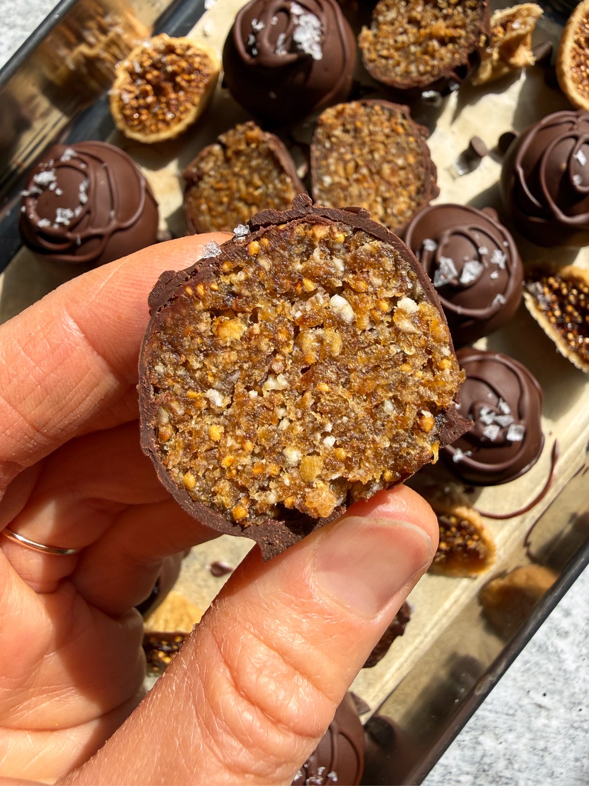 Holding a truffle that's been cut in half.