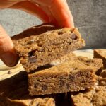 Grabbing a cookie bar from a stack.