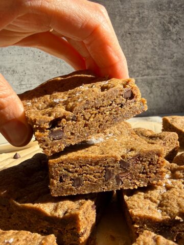 Grabbing a cookie bar from a stack.
