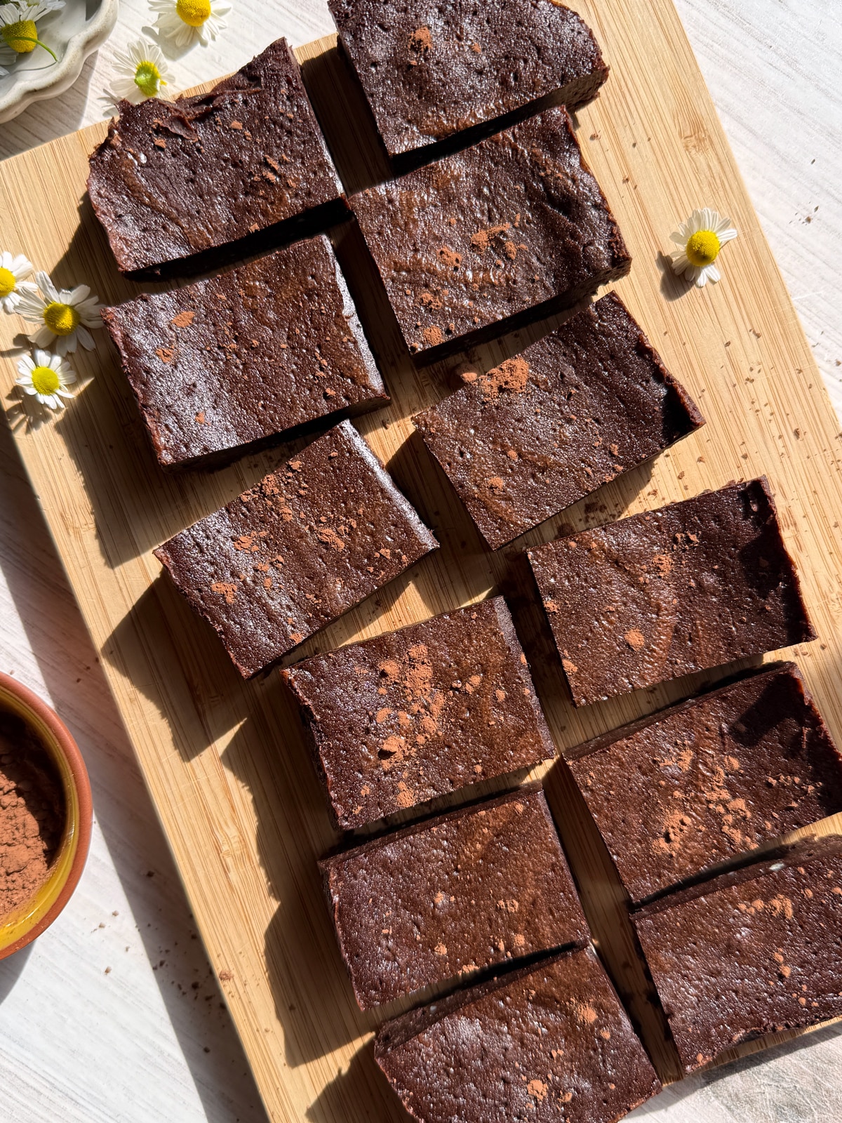 Top down view of buckwheat brownies on cutting board.