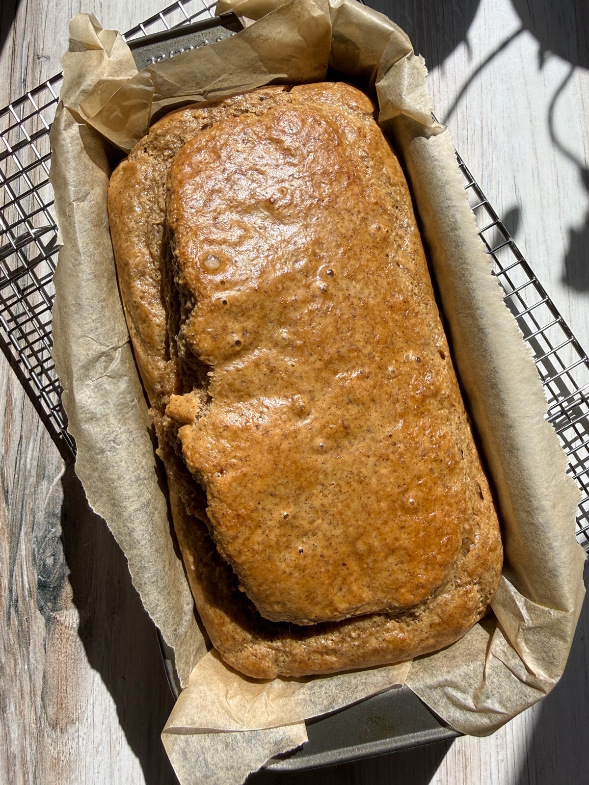 Freshly baked paleo sandwich bread cooling in the loaf pan.