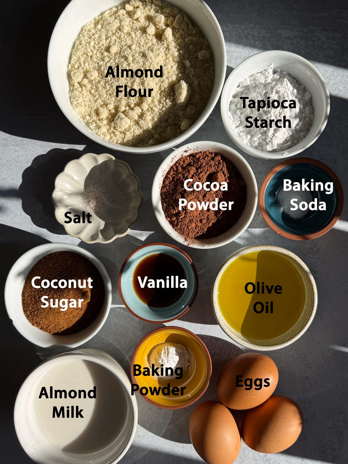 Ingredients needed to make gluten free chocolate olive oil muffins.
