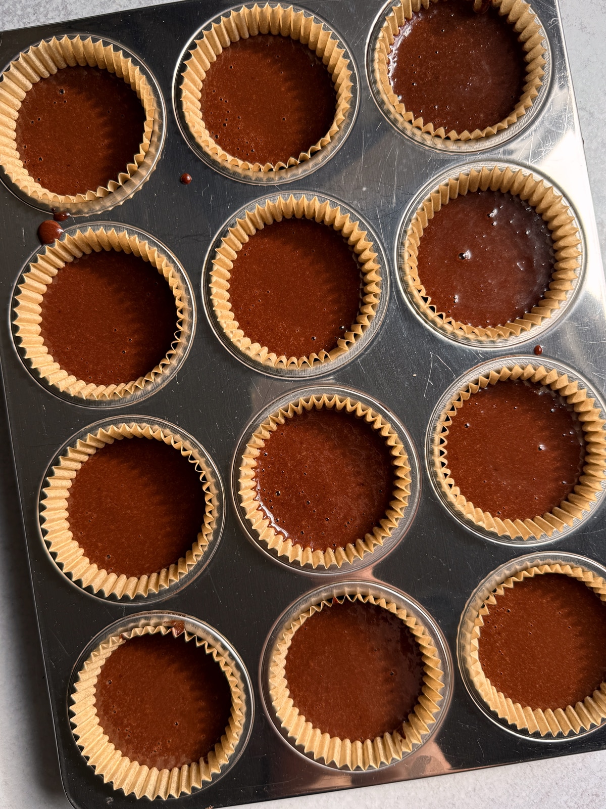 Muffin batter in muffin tin.
