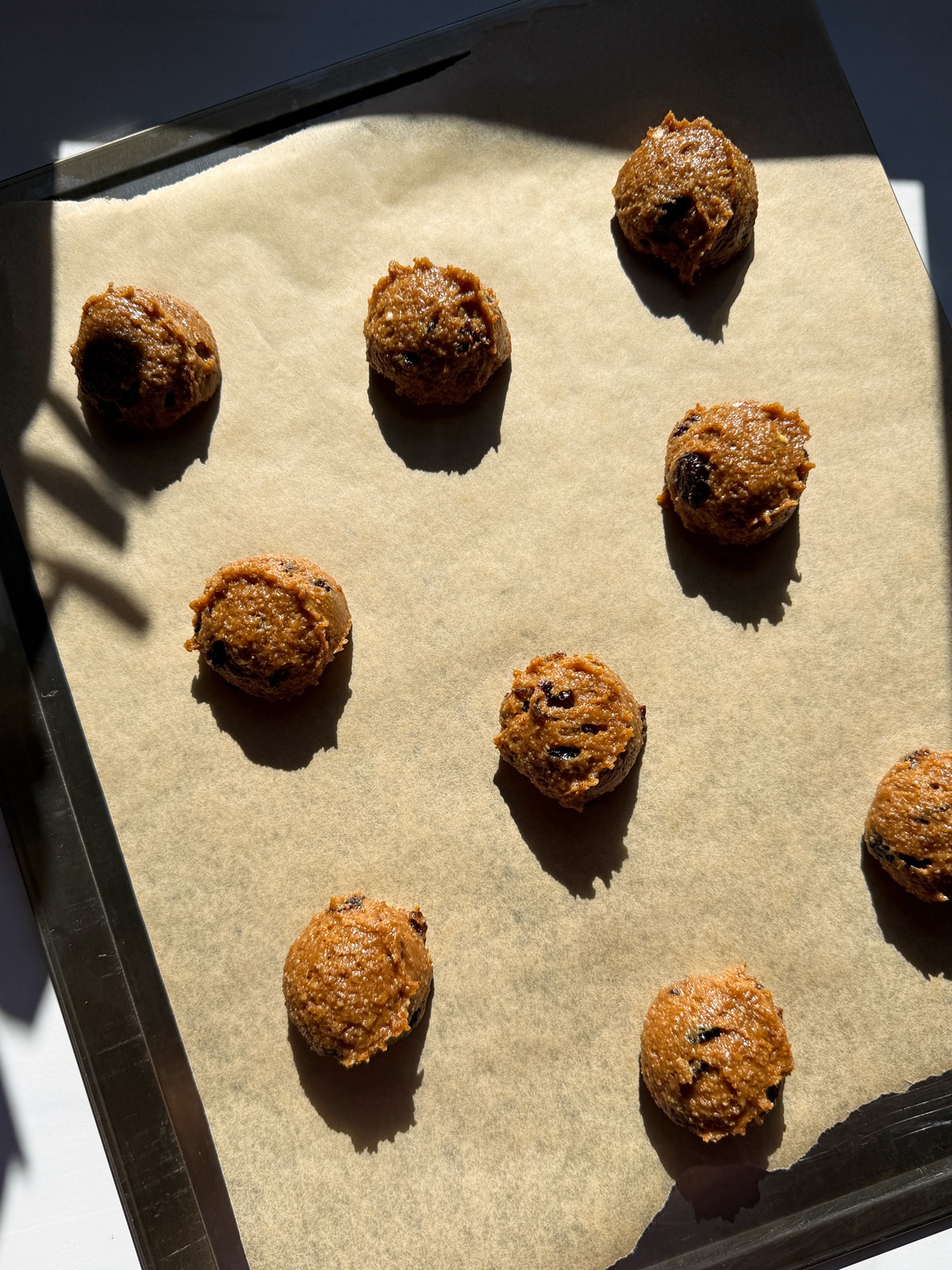 Cookie dough on lined baking sheet, ready to bake.