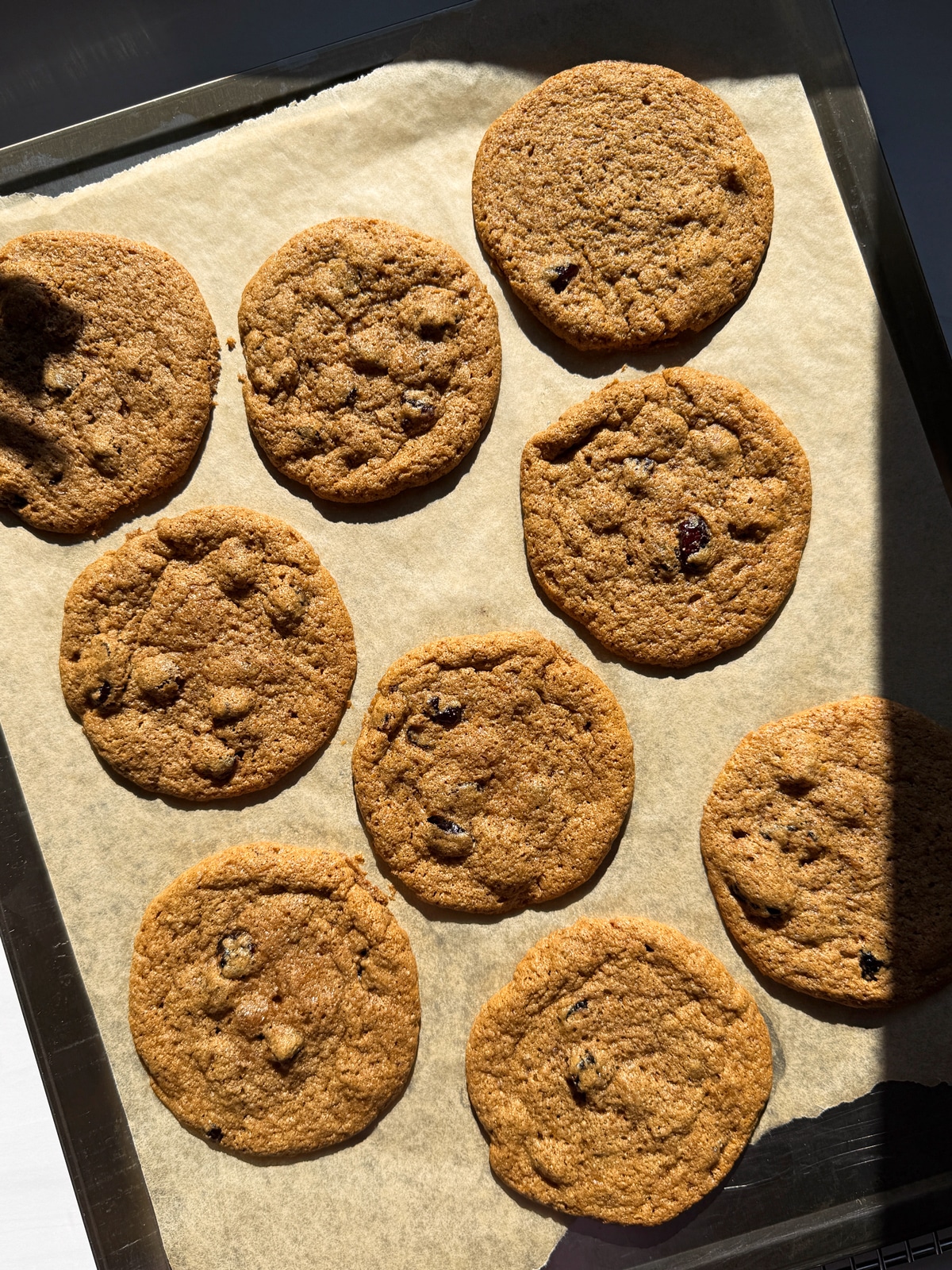 Baked cookies on lined baking sheet.