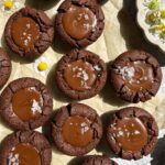 Top down view of chocolate cookie cups topped with flaked salt.