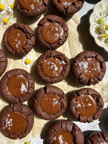 Top down view of chocolate cookie cups topped with flaked salt.