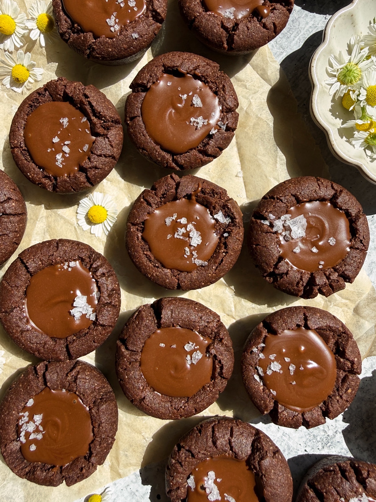 Top down view of chocolate cookie cups topped with flaked salt.
