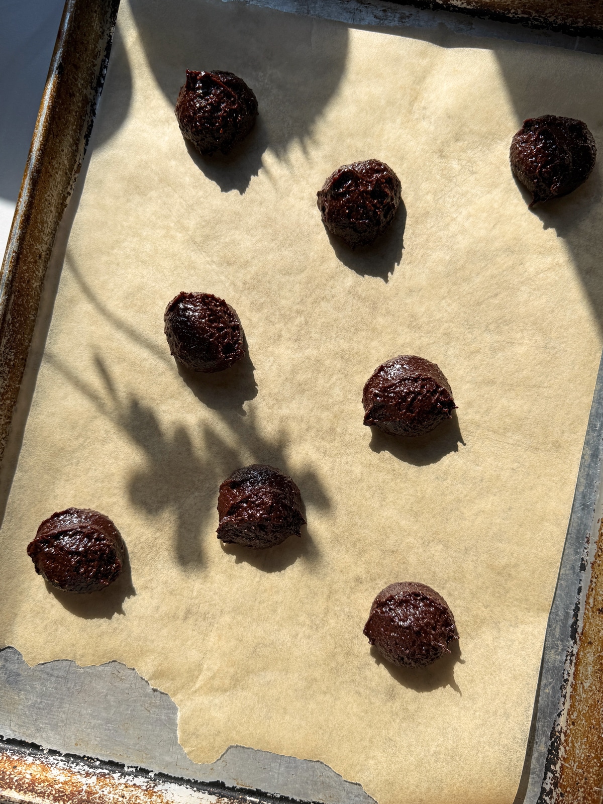 Cookie dough on lined baking sheet.