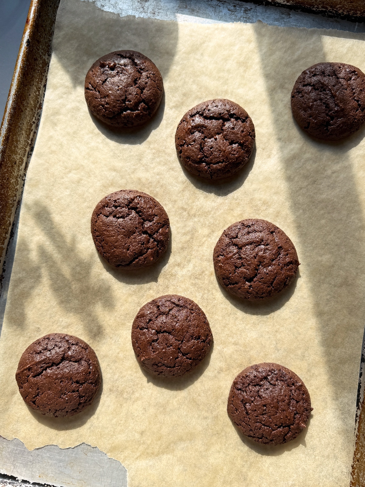 Baked cookies on lined baking sheet.