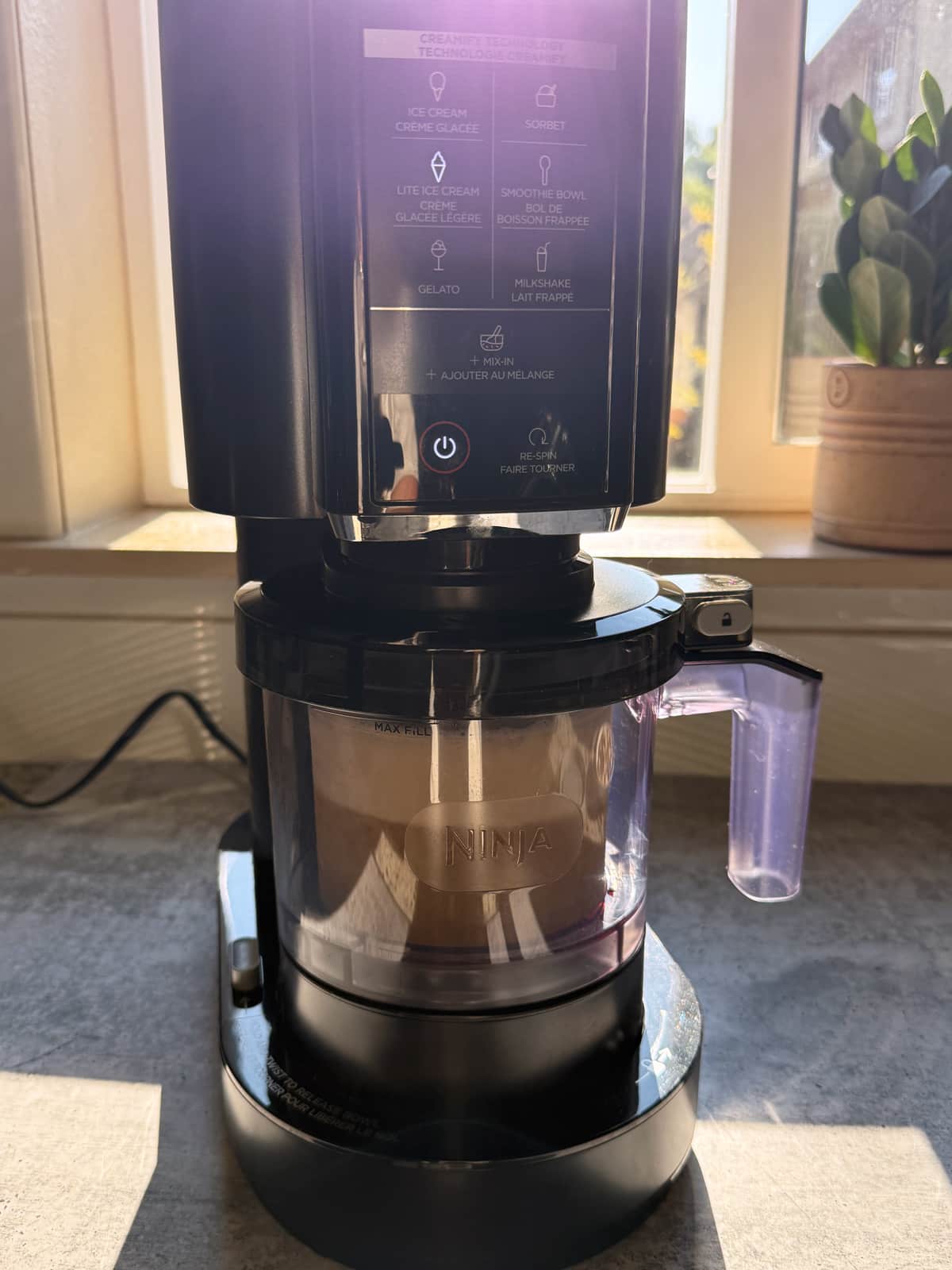 Blending the ice cream in the Ninja Creami machine.