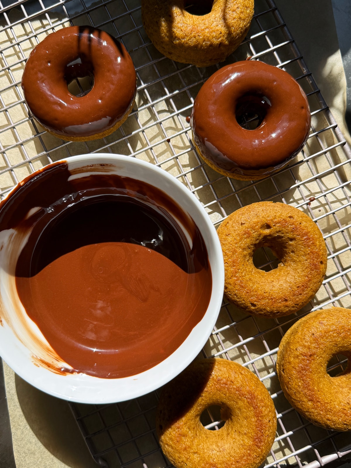 Dipping the donuts in the chocolate glaze.