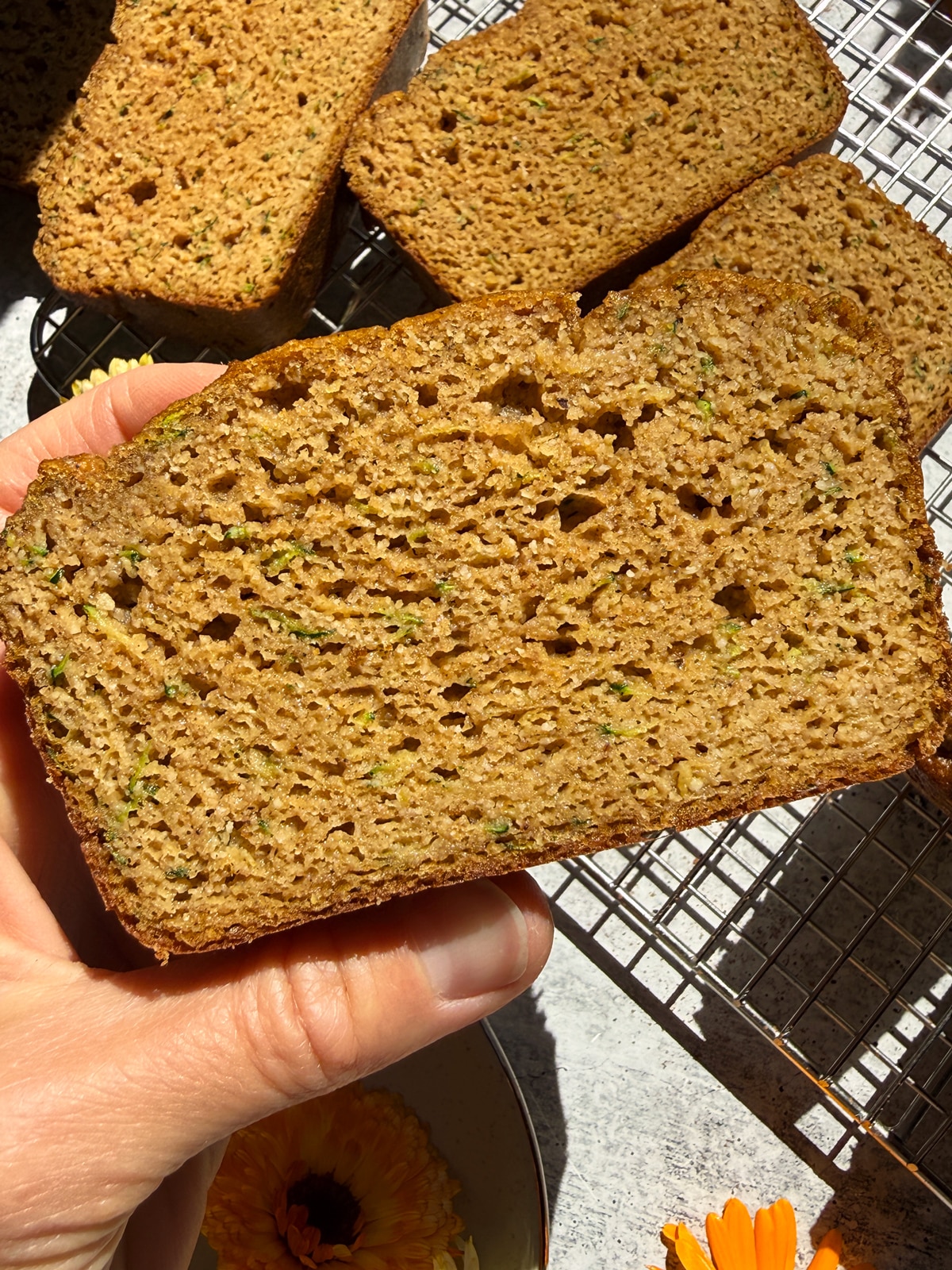 Holding a slice of bread.