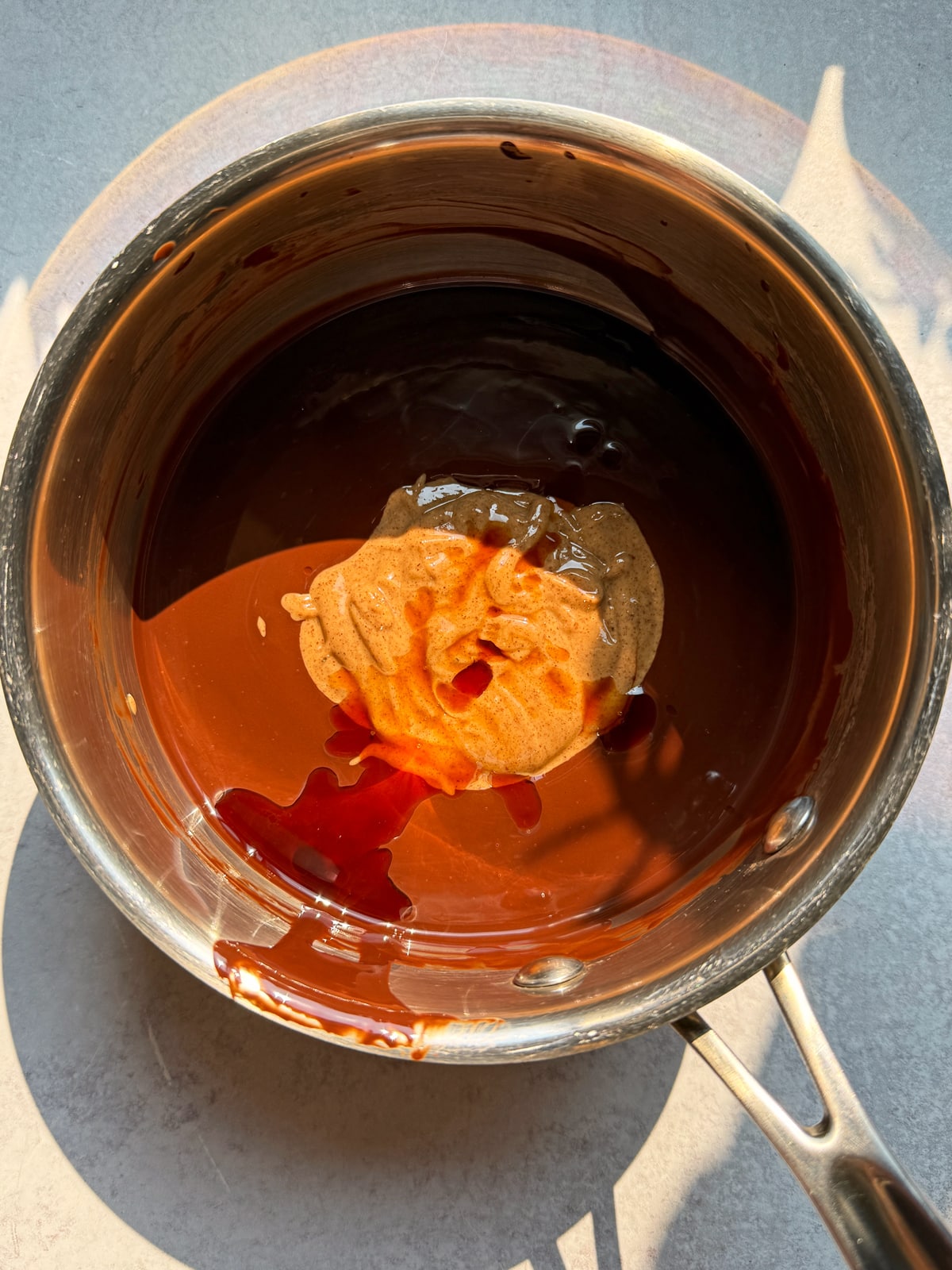 Almond butter, melted chocolate and vanilla in a saucepan.