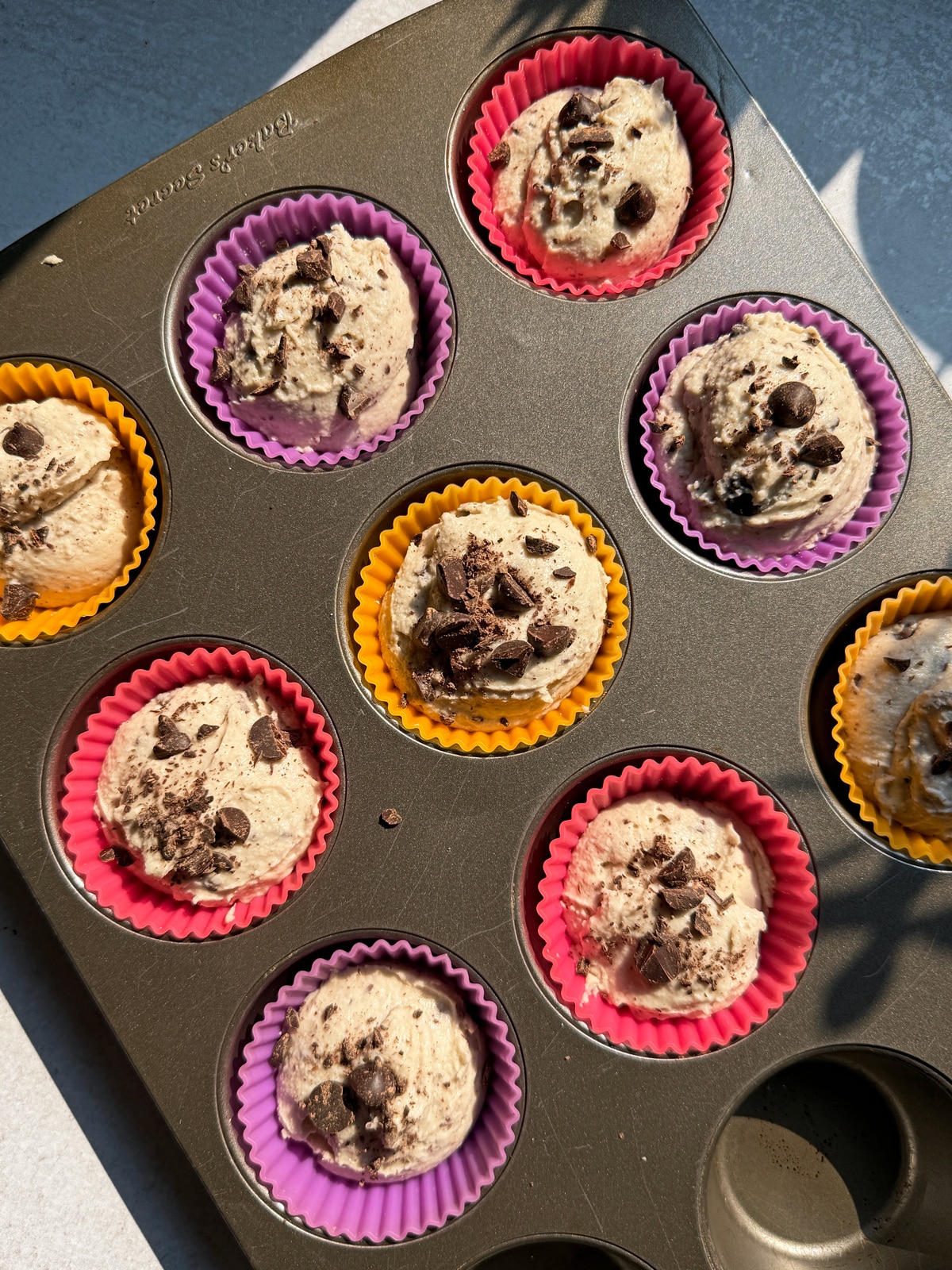 Unbaked muffins in muffin tin.