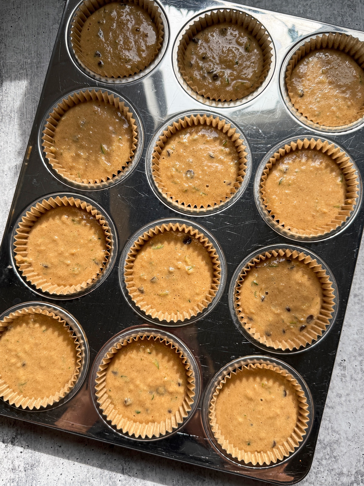 Batter in lined muffin pan, ready to bake.