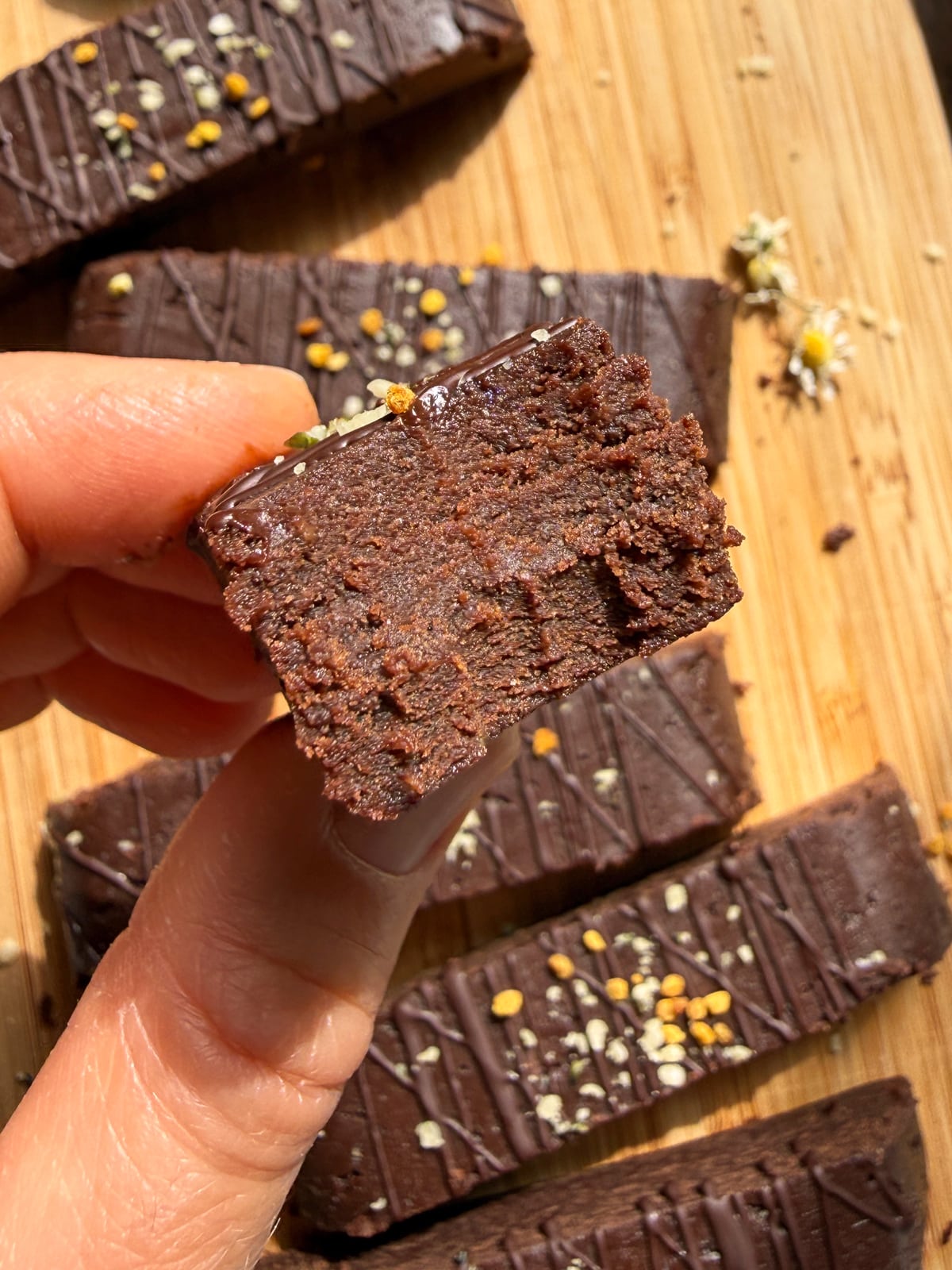 Holding a protein bar with a bite out of it to show the texture.