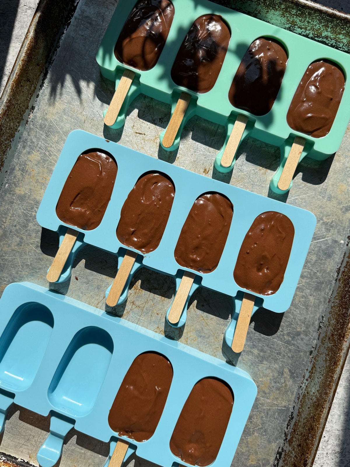 Fudge pop filling in popsicle mold.