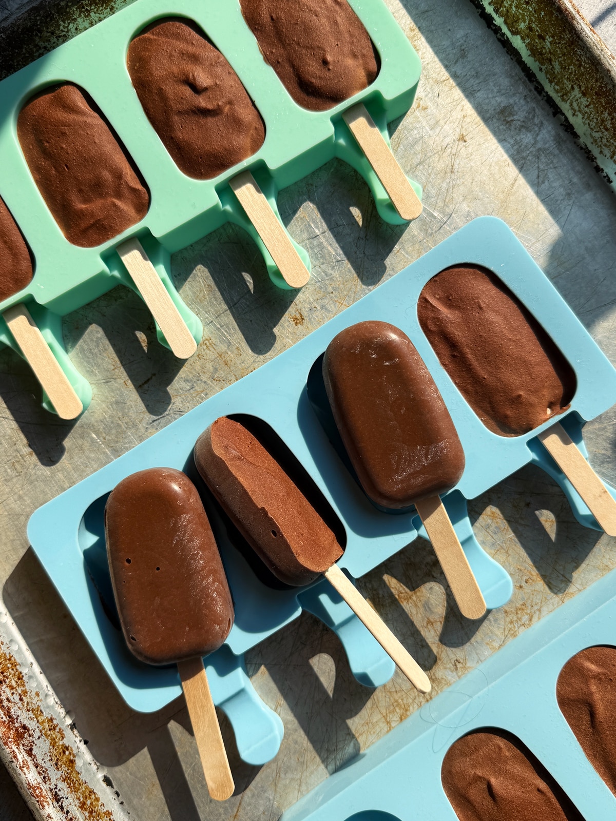 Taking the frozen popsicles out of the molds.