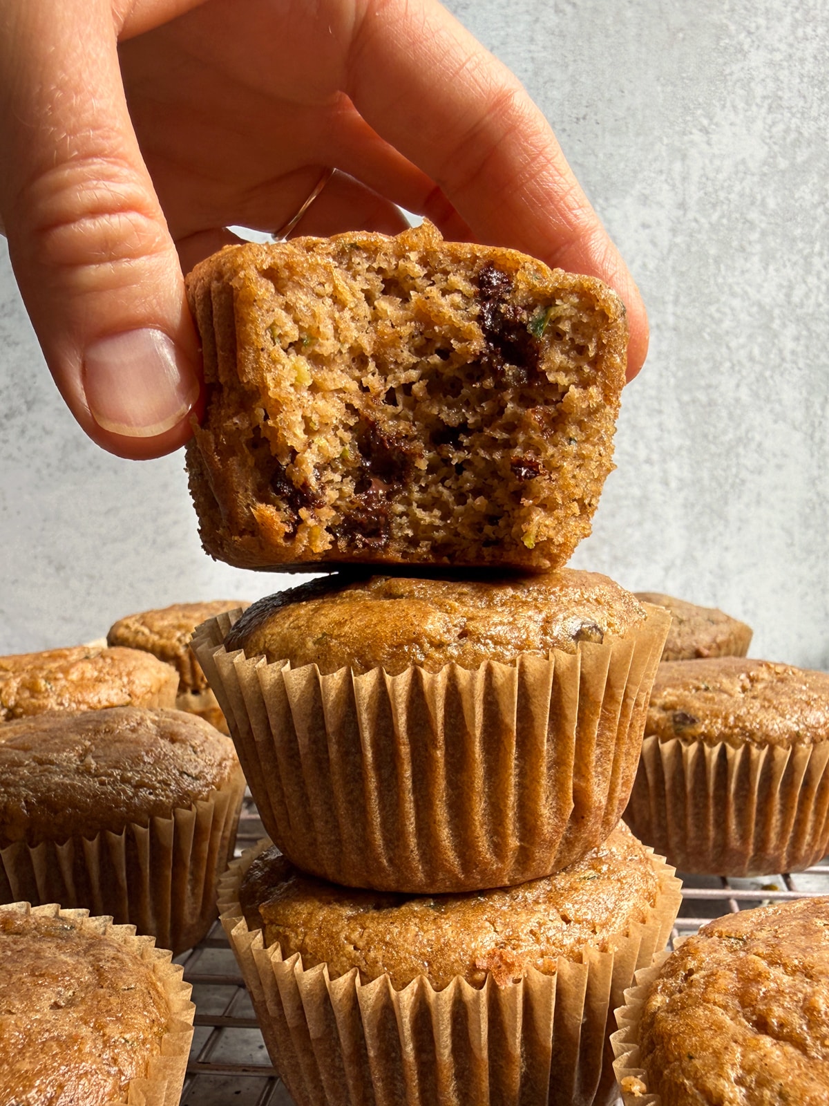 Grabbing a muffin from a stack of 3 muffins.