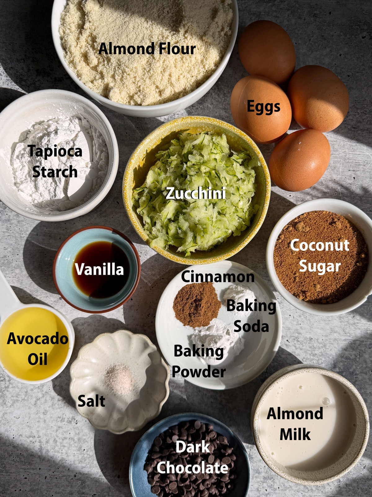 Ingredients needed to make gluten free zucchini muffins.