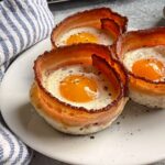 Bacon egg cups on a plate.