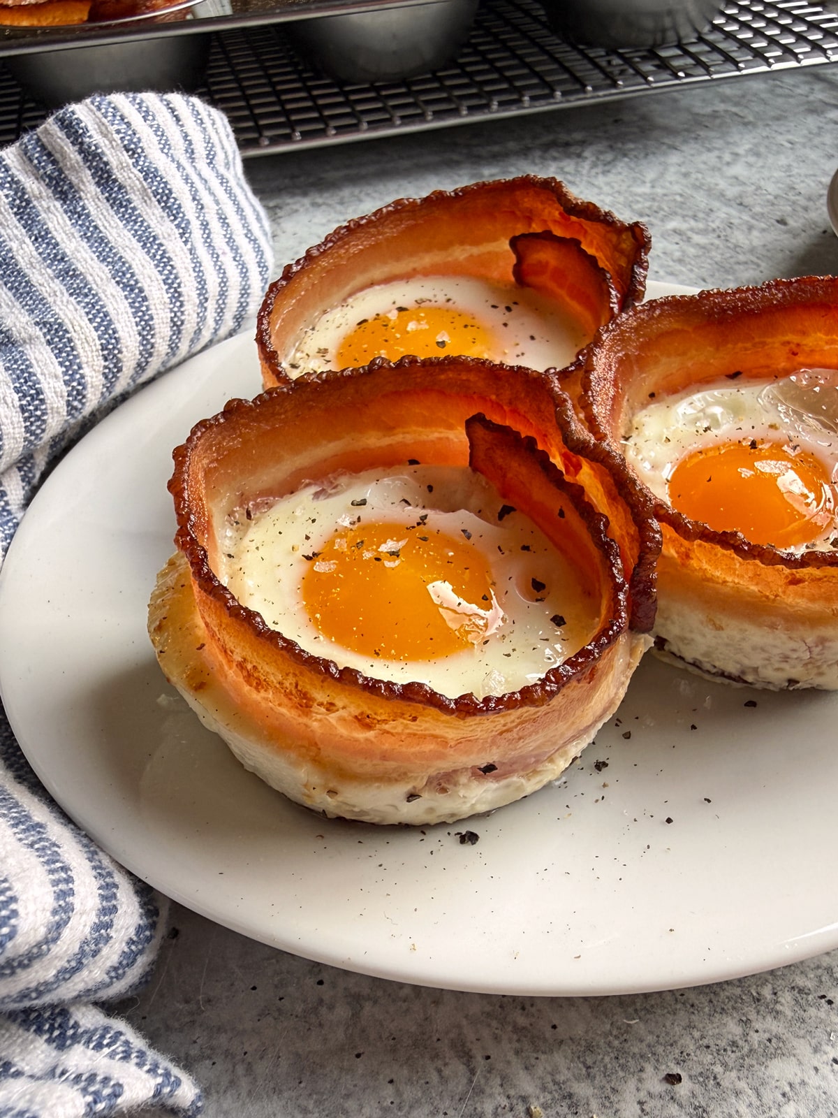 Bacon egg cups on a plate.
