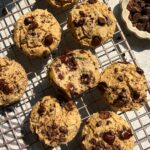 Vegan buckwheat muffins with chocolate chips on wire cooling rack.
