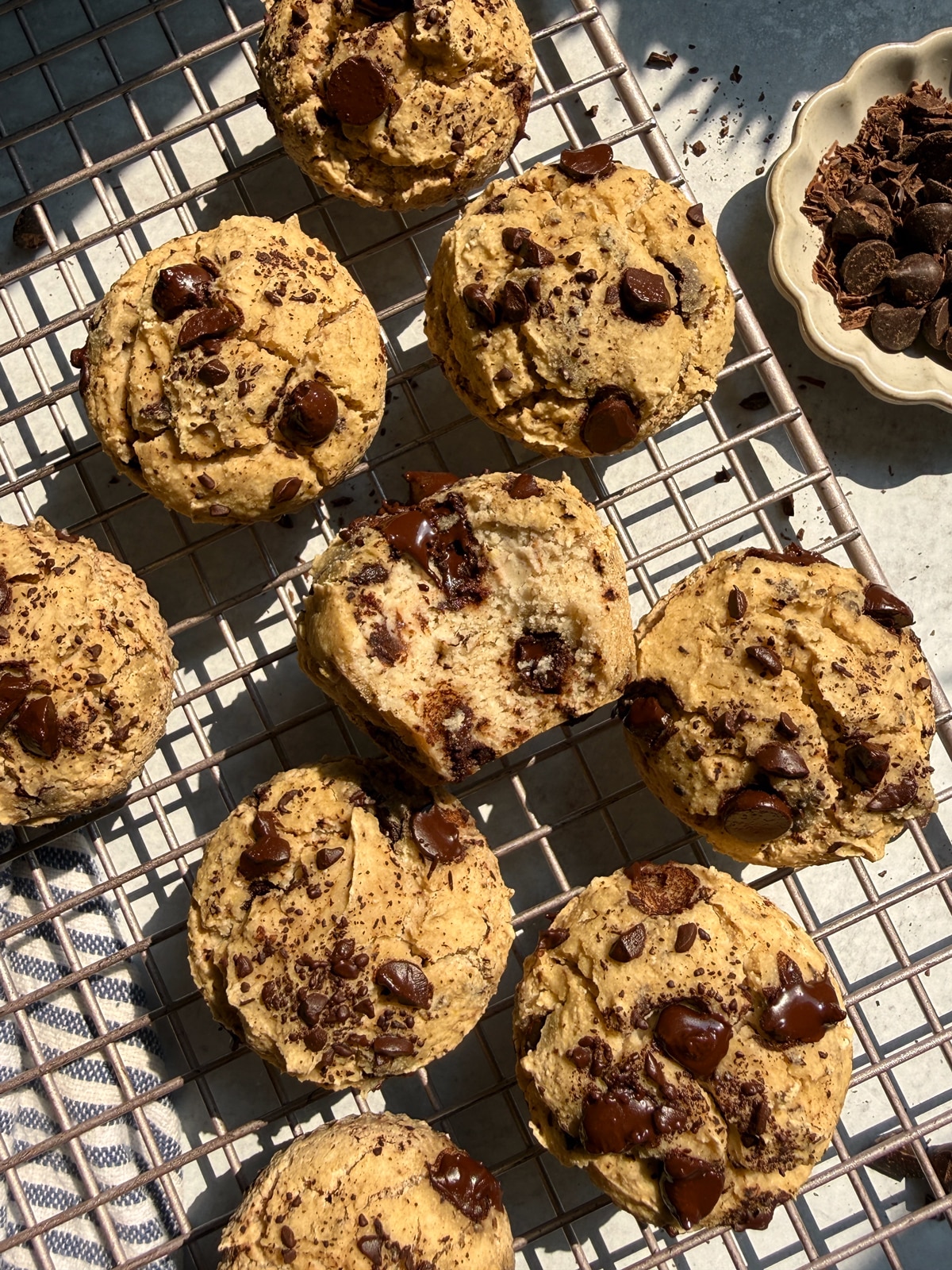 Vegan buckwheat muffins with chocolate chips on wire cooling rack.