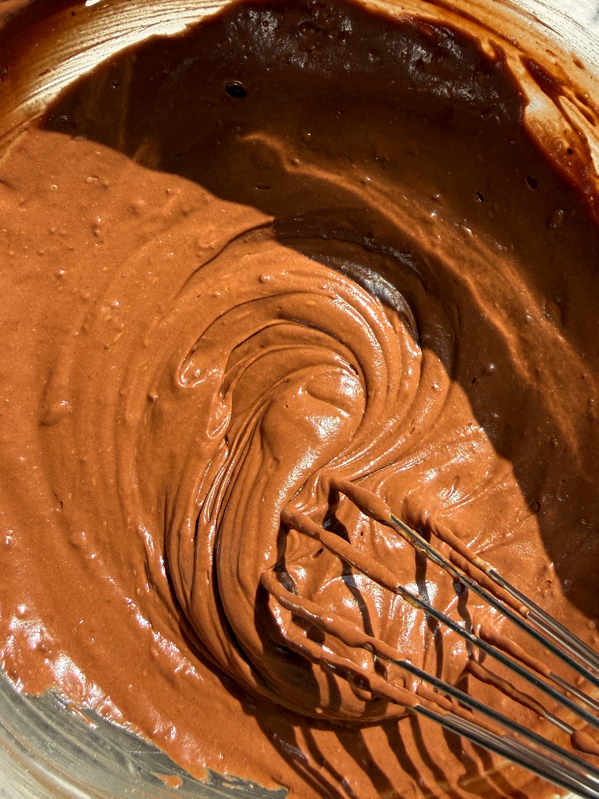 Mixed chocolate yogurt popsicle ingredients in mixing bowl.