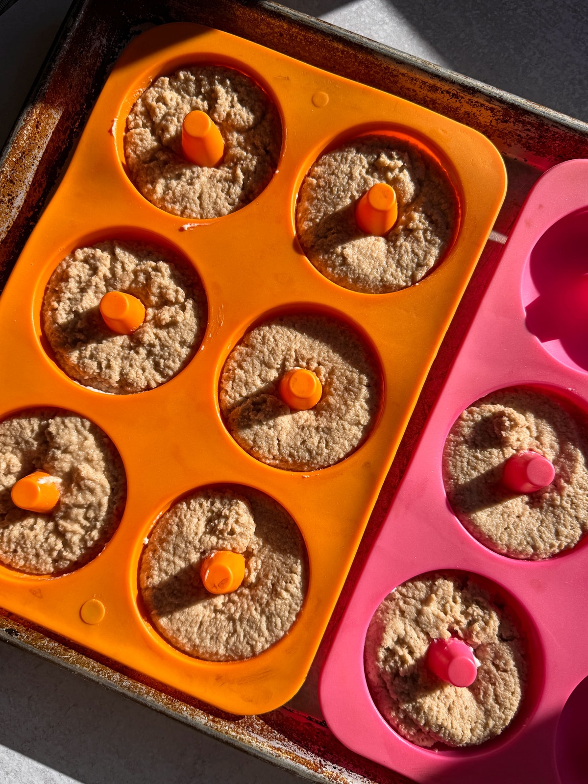 Unbaked donuts in silicone molds, ready for the oven.
